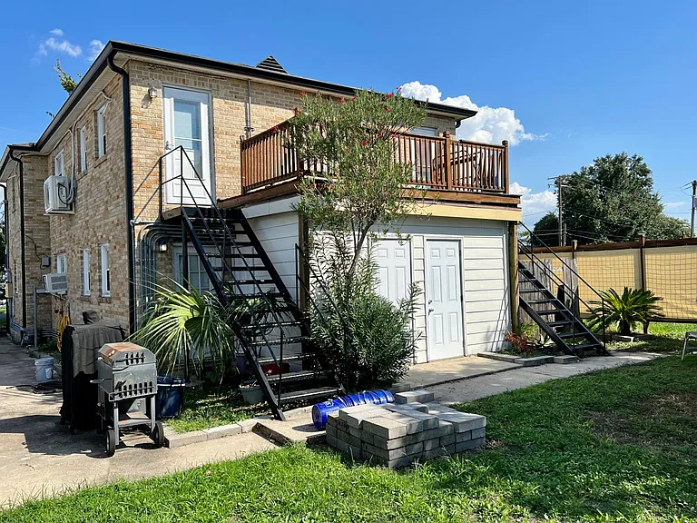 Rear Yard and Upper access with individual unit lower washer, dryer and hot water room. Unit has storm door and upper deck.