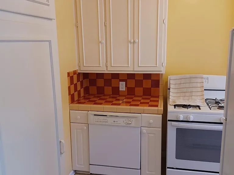 Kitchen offers tons of cabinets and storage space, newer gas range/oven, dishwasher, and full-size fridge.