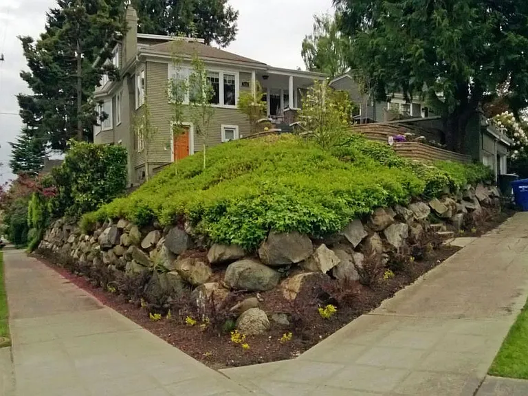 Street View. The house is perched up on the hill for good views. 1 car garage on top right. Additional parking available on street.