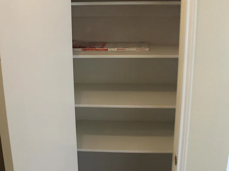 Hall linen closet at bottom of stairs; new carpet and paint
