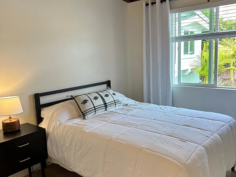 One full size bed with nightstand, linens, comforter and nightstand. Natural unique feel, with wood beamed ceilings and ceiling fan.
