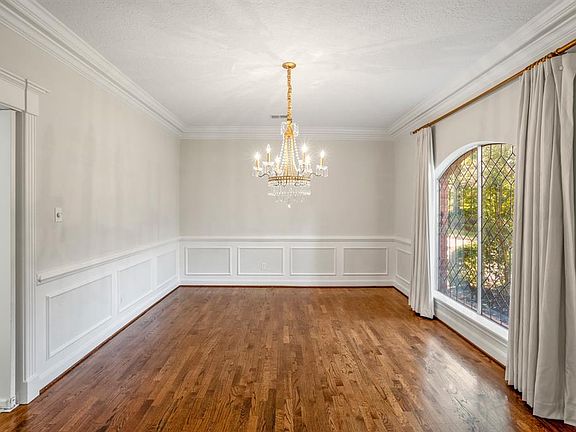 The formal dining has plenty of space for a large dining room table while still having quick access through the swing door located on the left to get to the kitchen. Don't miss a second look at that OUTSTANDING chandelier!