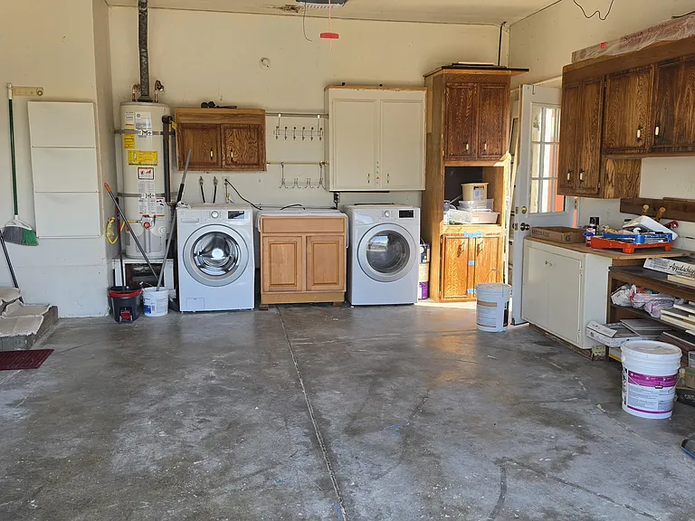 functional garage with washer and dryer room for storage and room to park a car
