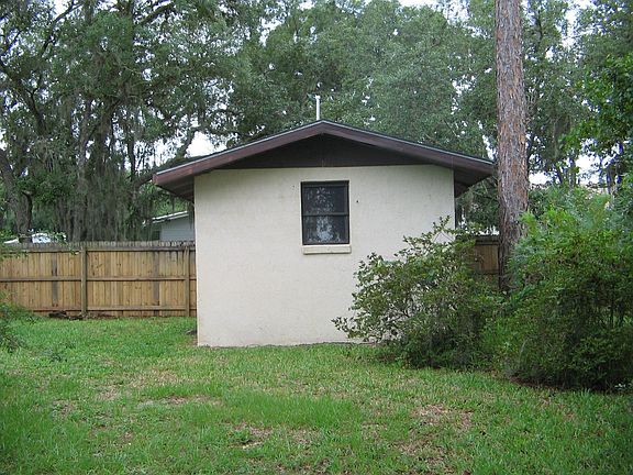 stucco shed in back