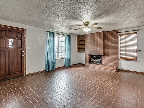 Lovely living area with brick floors and gas fireplace. Lots of natural light.