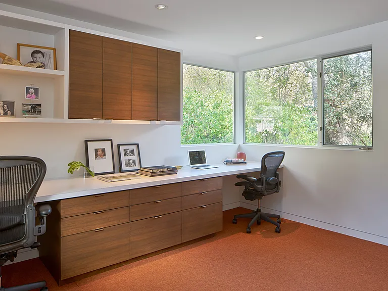 Convenient and private home office upstairs and accessed from primary bedroom with multiple desktop work spaces.
