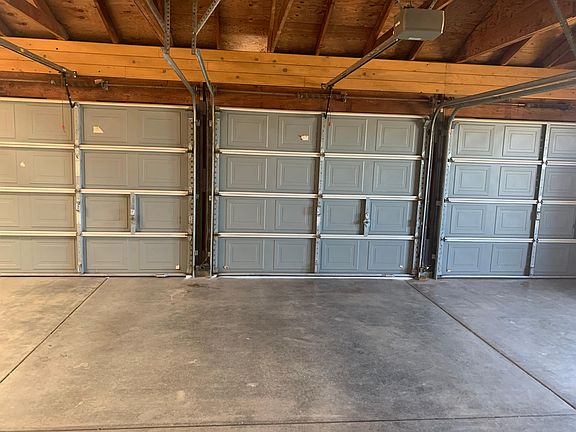 Large 3 bay garage with 2 having garage doors