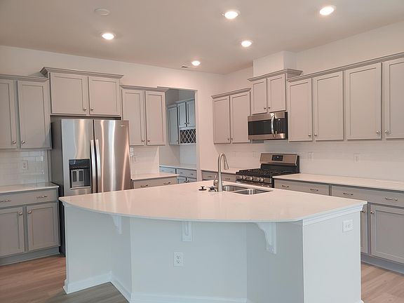 Kitchen with gas cooktop and quartz countertop.