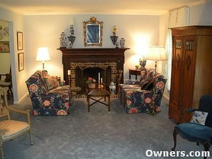 Living room with wood burning fireplace.
