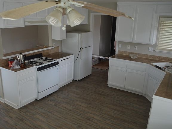 Kitchen newly painted with new grey plank vinyl flooring
