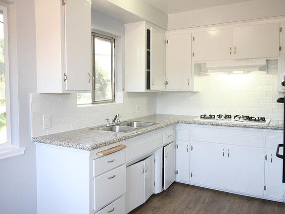 New granite counters, subway tile backsplash. Built-in gas cooktop and oven.