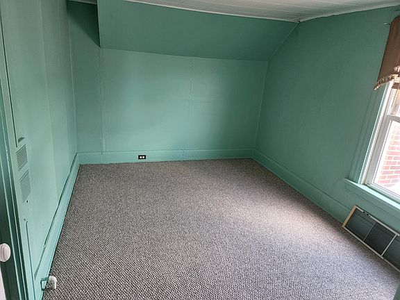 Bedroom next to bath with new carpeting.