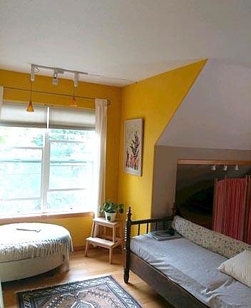 Living area with new of storage or TV nook beyond couch