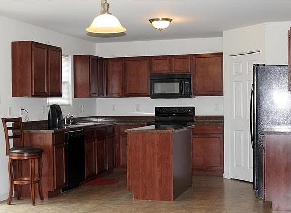 Kitchen includes all appliances. Sliding glass door leads to back patio.