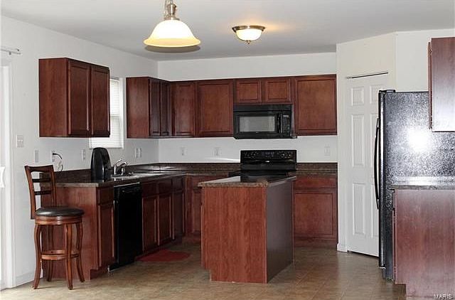 Kitchen includes all appliances. Sliding glass door leads to back patio.