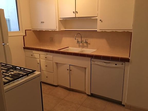 Kitchen view with dishwasher, stove and refrigerator