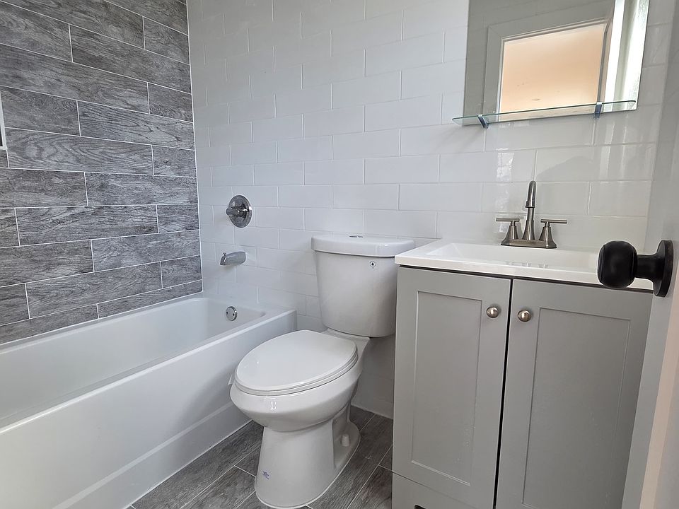 Master Bedroom Bathroom

The master bedroom includes a private full bathroom with a modern design. Features include a tiled bathtub/shower combination, updated vanity with storage, sleek fixtures, and easy-to-clean tile flooring.