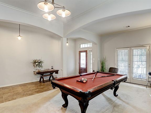 The formal living room at the front of the home could easily be drywalled in and separated to create the perfect office space!