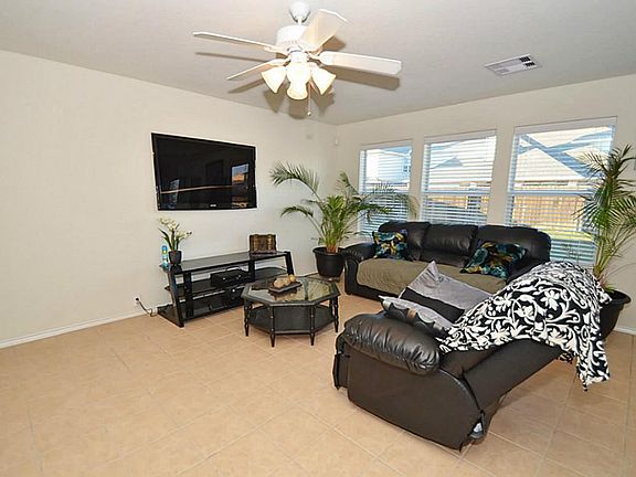  Entry leads into the living room with large neutral tile flooring