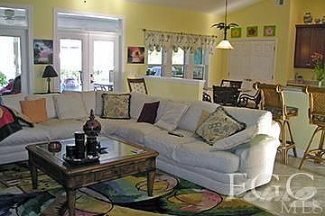 The Kitchen has a separate eating area and a Breakfast Bar. Two sets of Double French Doors lead out