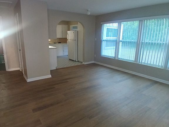 Living area with new floors. The entire home, including this living area has been freshly painted.