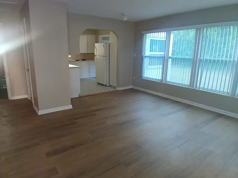 Living area with new floors. The entire home, including this living area has been freshly painted.