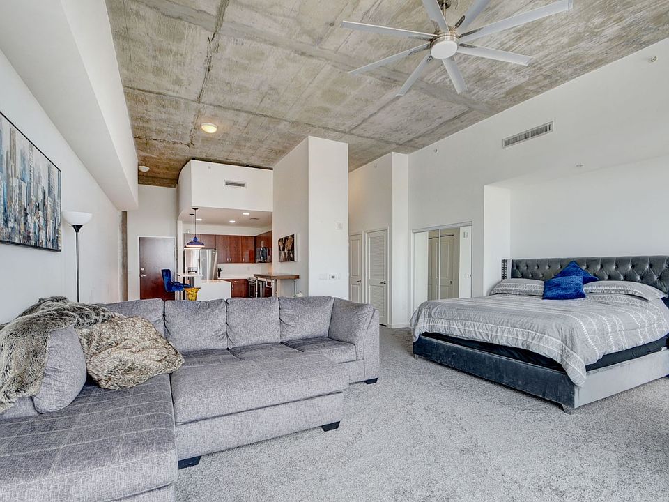 Furnished with king bed sectional and barstools.