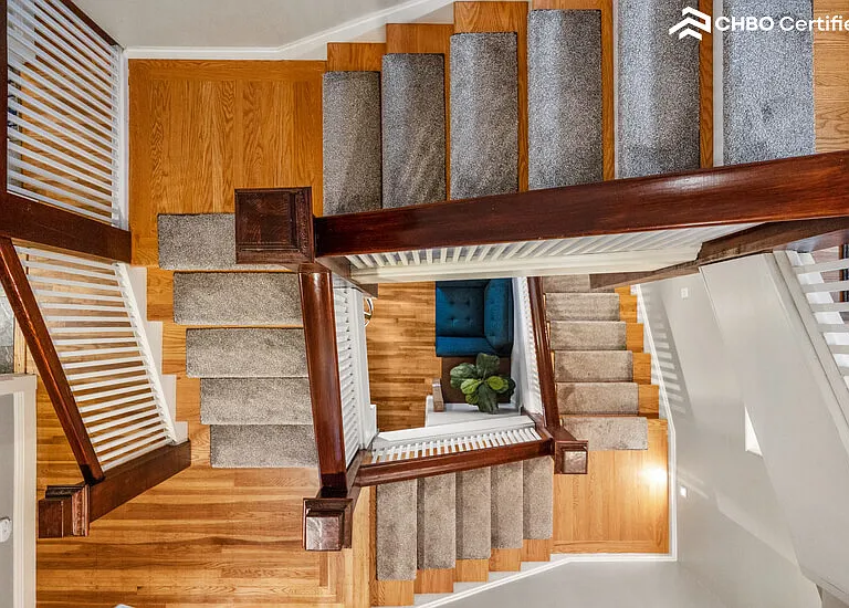 Wider view from loft stairs down 2 flights to foyer