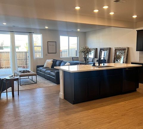 Great Room view from entry. Three large mirros, dining table with plenty of setaing. Large island and kitchen fully stocked.