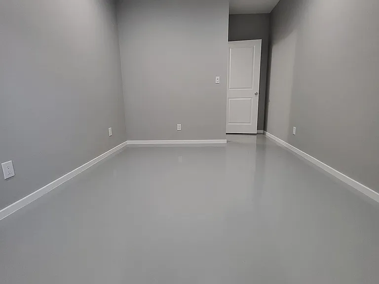 Bedroom #3. 9' ceilings with 4 recessed LED lights on a dimmer switch. New Epoxy flooring.