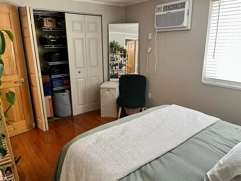 Large closet with ample storage and shelving, in wall AC unit cools entire apartment