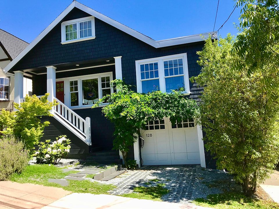 Street view with front porch, driveway, and garage