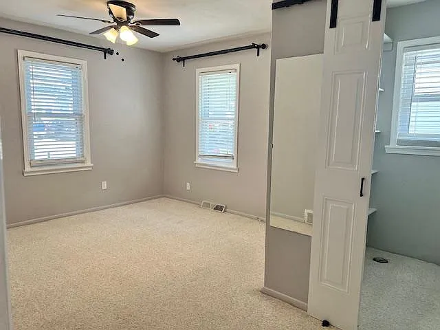 Primary bedroom with walk in closet that have built ins