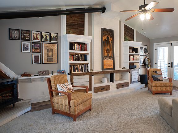 Living room with light up built ins + faux fireplace. Inquire about fully furnished option.