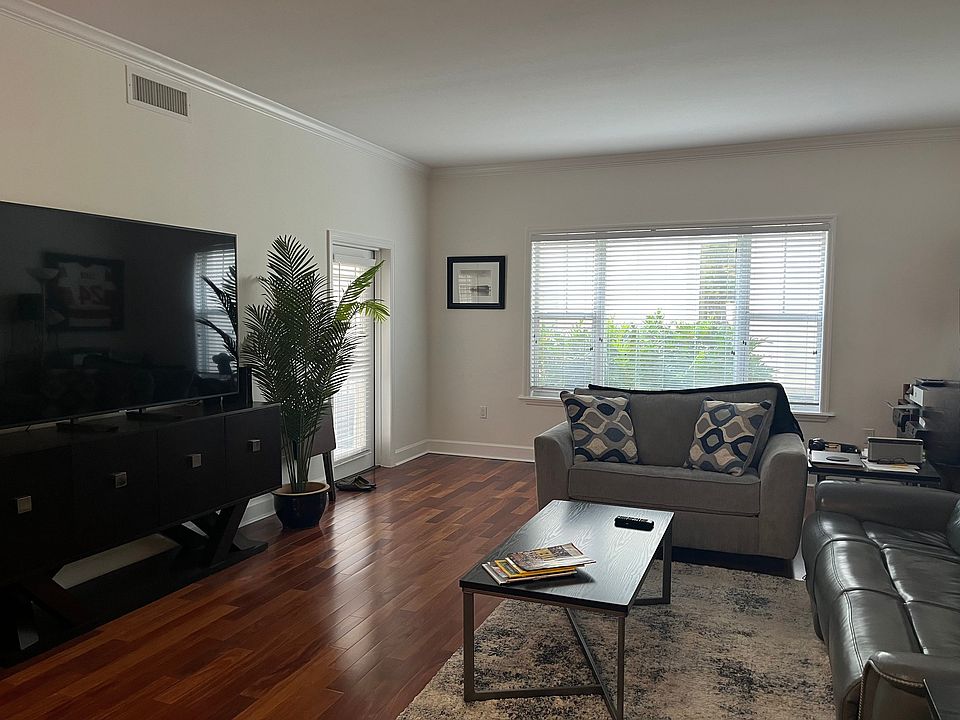 Living room area with large window and door to patio