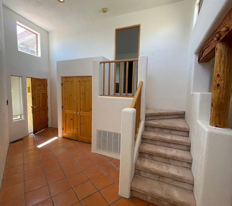 Entry foyer with high ceilings, steps up to master bedroom