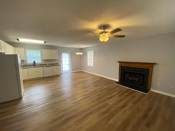 The living room is open to the eat in Kitchen area. The back door leads out to the back deck.