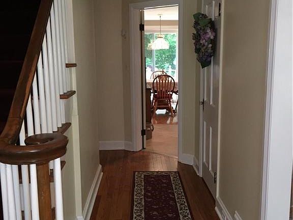 A wide foyer and stairwell at the entrance. Dining room to the left, living room to the right. The breakfast room straight ahead is central to the kitchen and large family room.