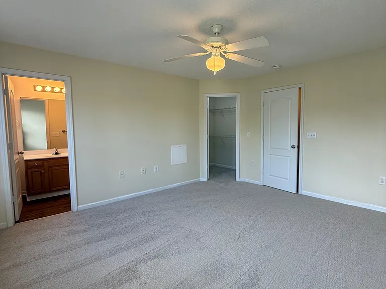 1st Master bedroom with view of bathroom and walk in closet.
