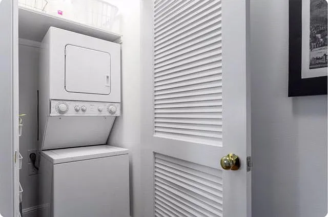 Stackable washer and dryer outside the main bedroom.