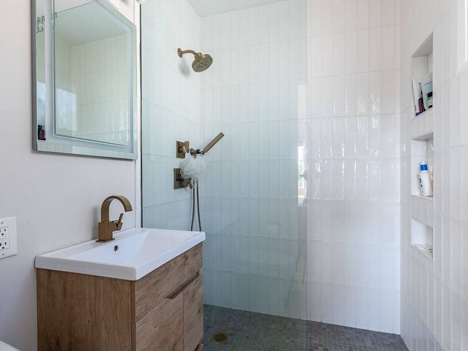 Walk-in shower, LED lit mirror in new bathroom.