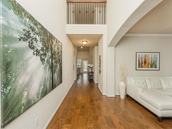 Grand entry way with high ceilings and gorgeous engineered wood floors.