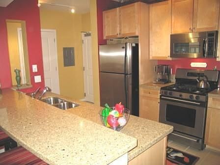 Fabulous kitchen with maple cabinets and stainless steel appliances.