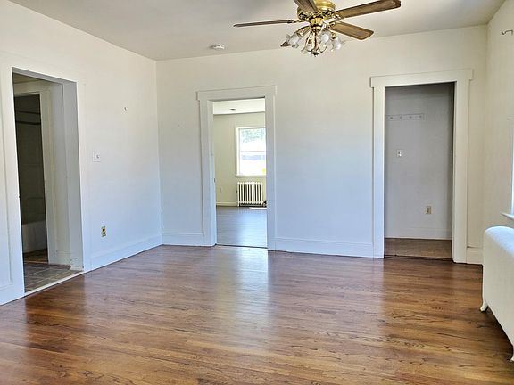 Sunny dining room, ceiling fan, newer laminate flooring.