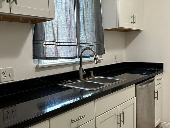Granite counters, double sinks. 
Dishwasher and garbage disposal.
Tile floor.