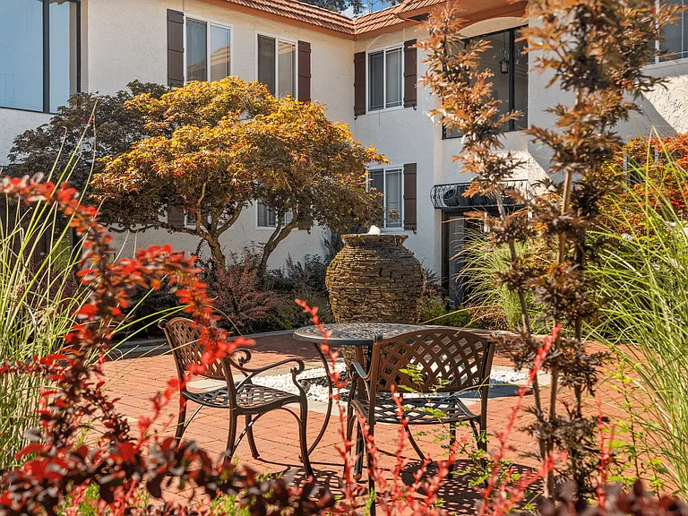 Your peaceful courtyard escape_perfect for relaxing under the trees.