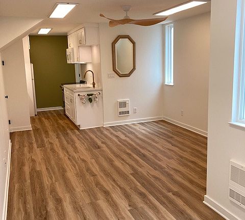 Studio living space with easy to maintain vinyl flooring throughout