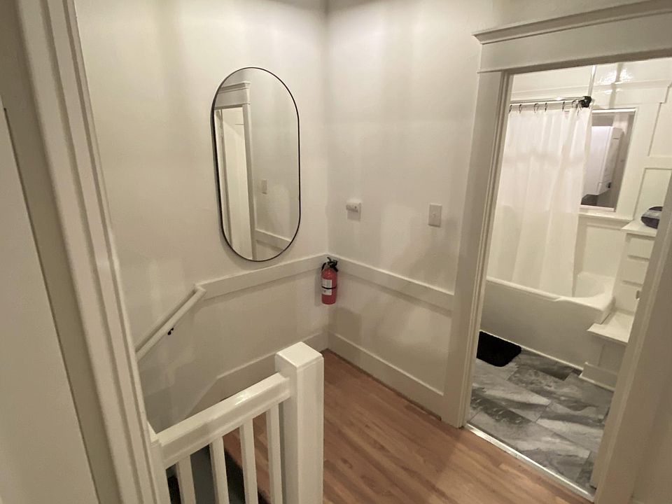 Private foyer with access to bathroom, living room, and bedroom.