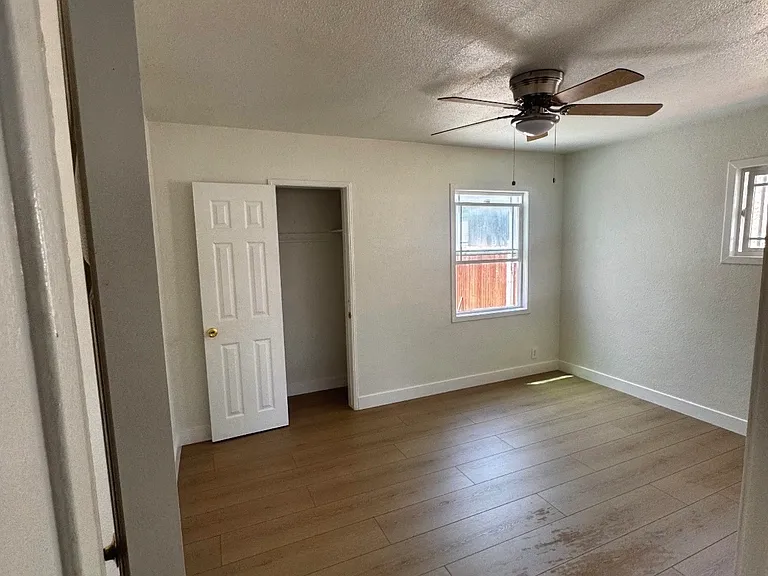 Cozy Bedroom With Ample Natural Light and Ceiling Fan