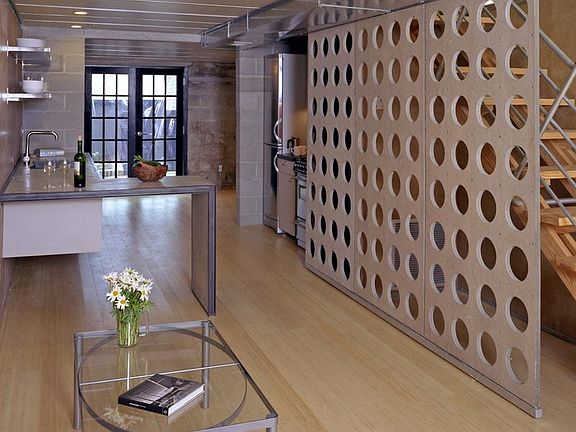 Very open, sliding screen hides furnace and storage